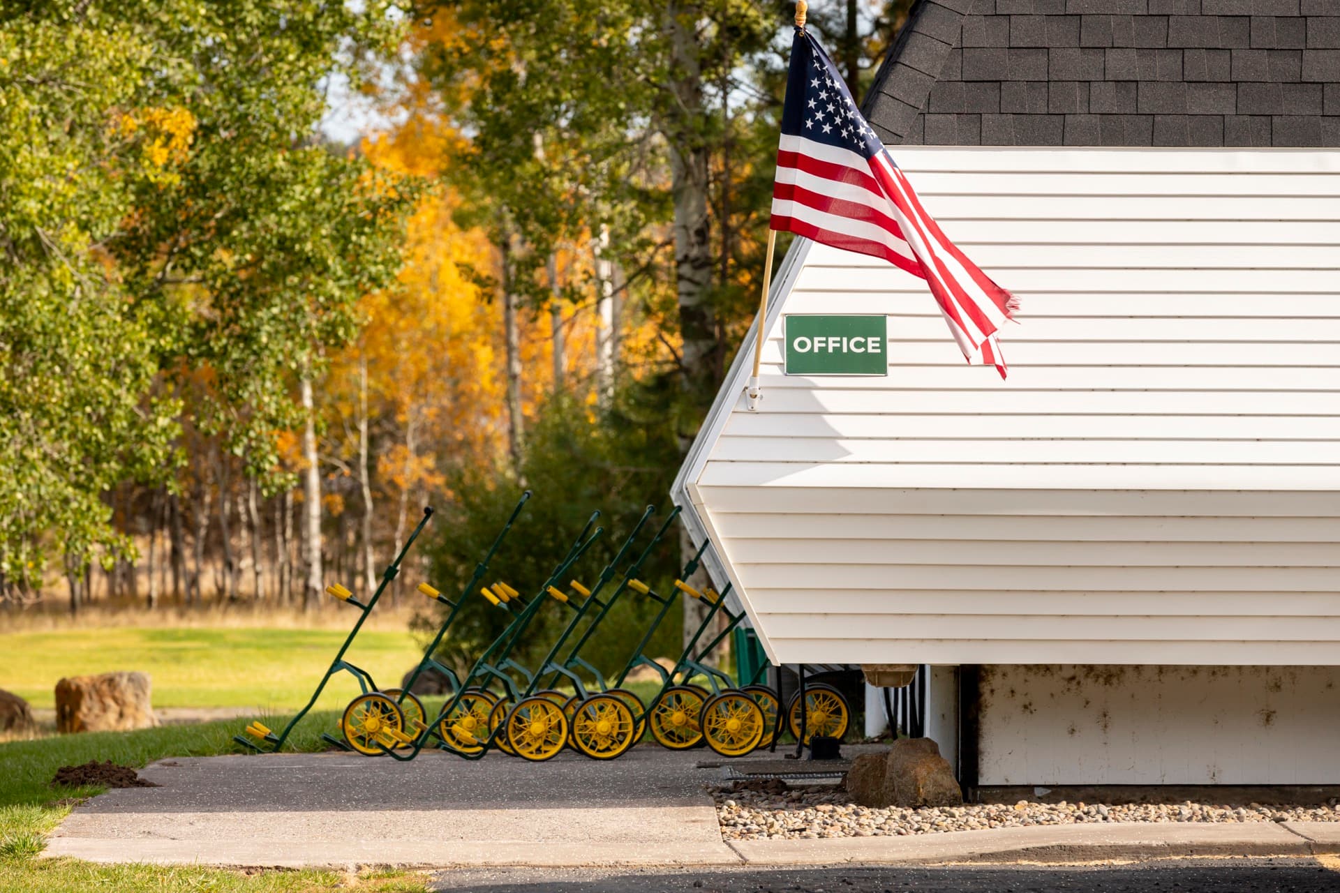 Round Lake Community office with American flag and golf cart rentals